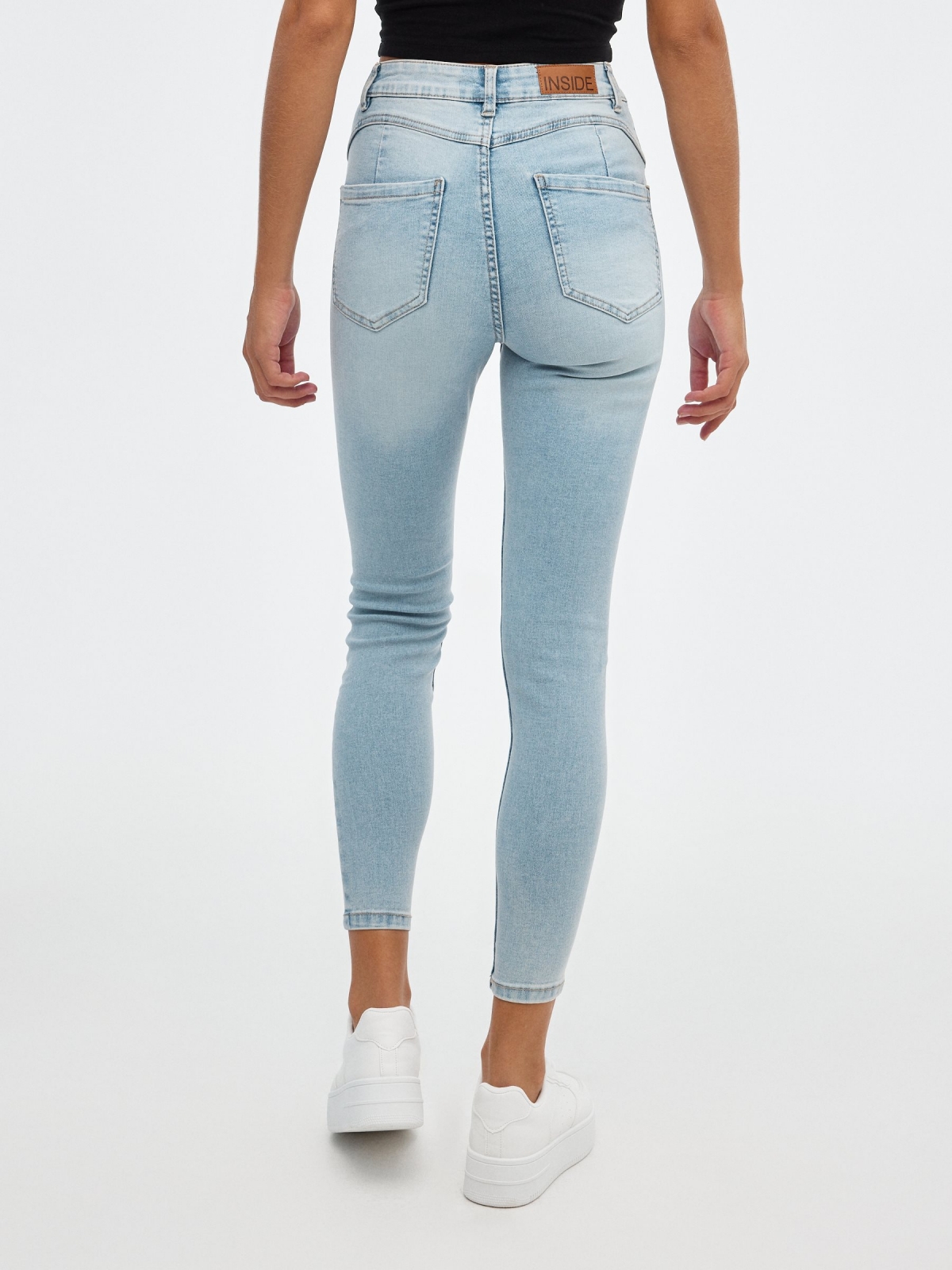Skinny jeans mid rise push up light blue middle back view