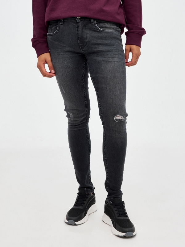 Black super skinny jeans with ripped black middle front view