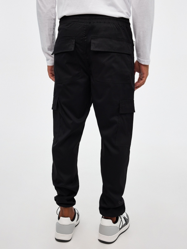 Jogger pants with adjustable ankles black middle back view