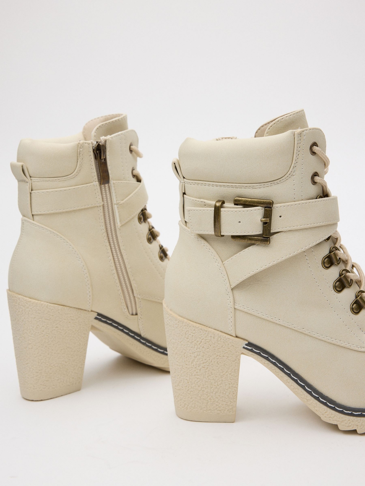 Ankle boots with crossed buckle white detail view