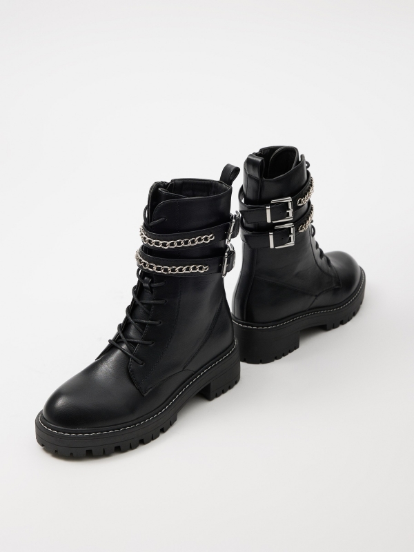 Ankle boot with buckles and chain black detail view