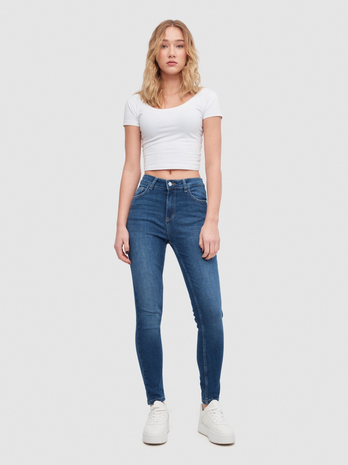 Ripped mid-rise skinny jeans dark blue front view