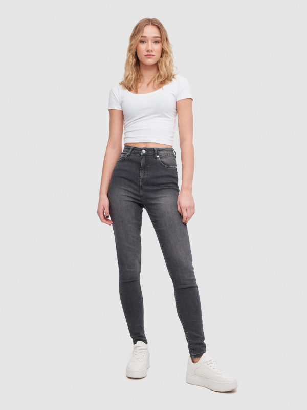 High-waisted skinny jeans with ripped black front view