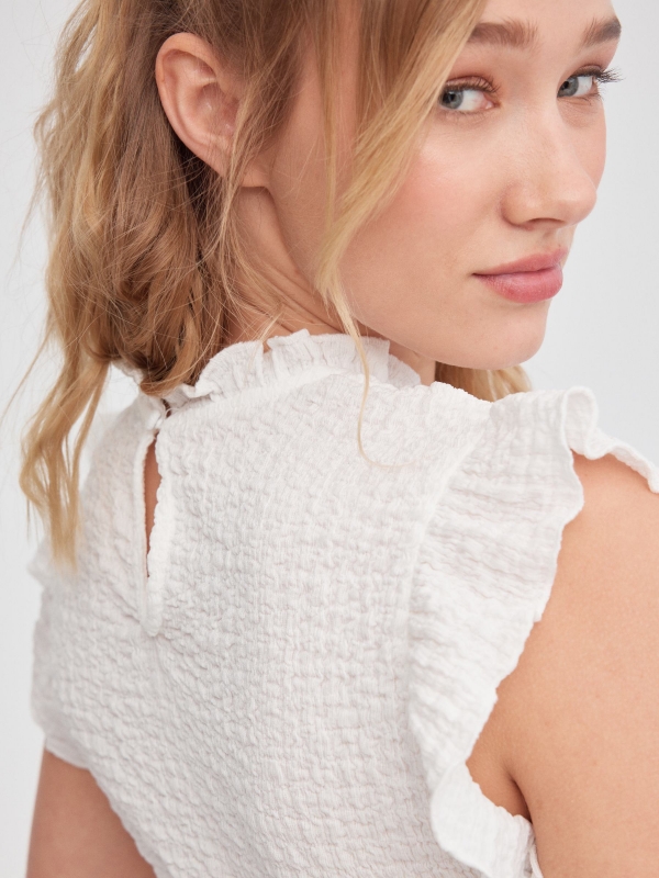 Ruffled top with cut out back white detail view