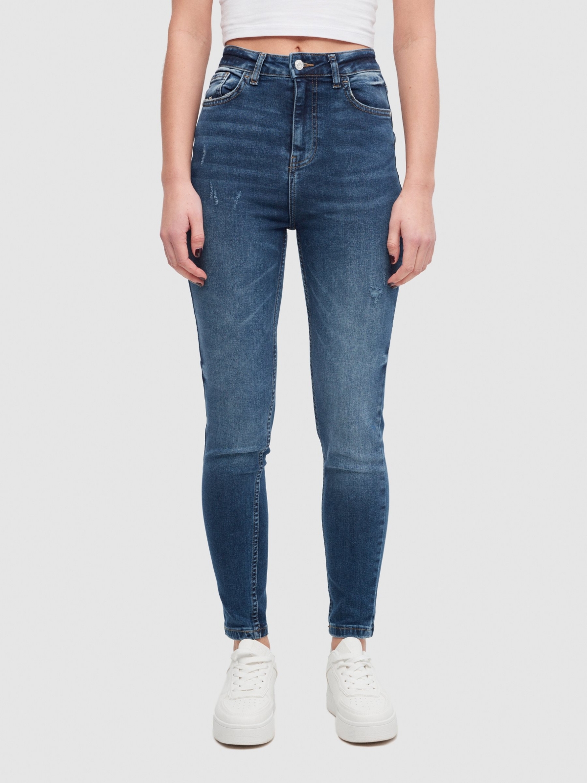 High-waisted skinny jeans with ripped dark blue middle front view
