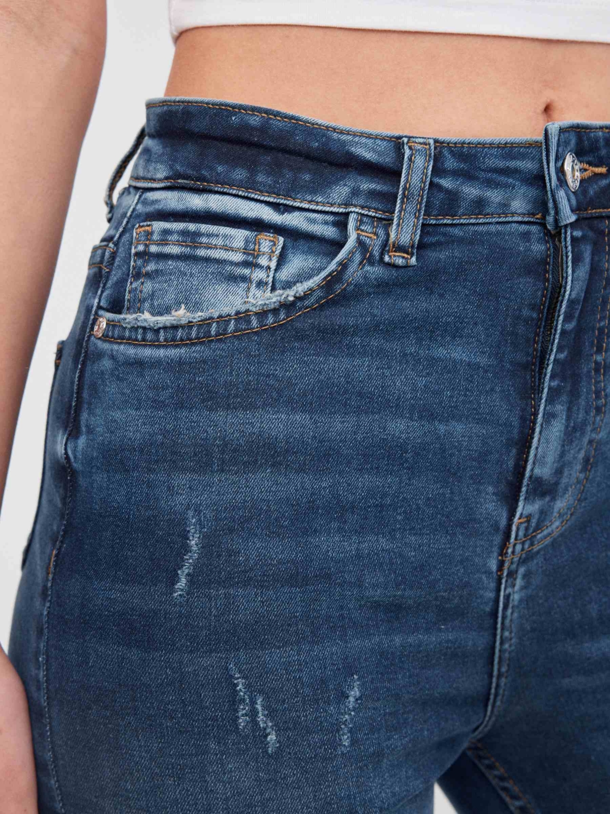 High-waisted skinny jeans with ripped dark blue detail view