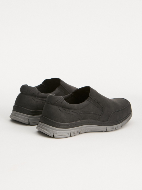 Sapato com aplicações elásticas preto vista traseira 45º