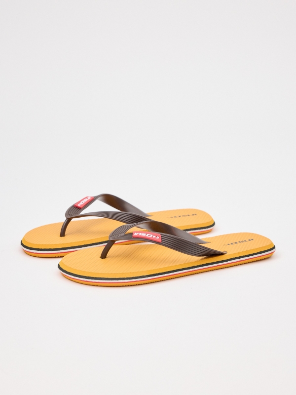 Yellow flip flop with engraved strips mustard 45º front view