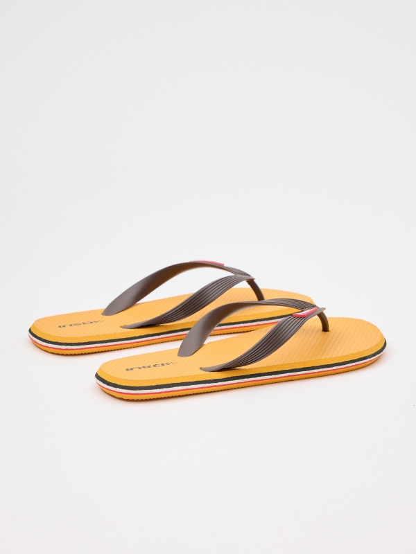 Yellow flip flop with engraved strips mustard 45º back view