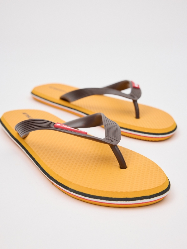 Yellow flip flop with engraved strips mustard detail view
