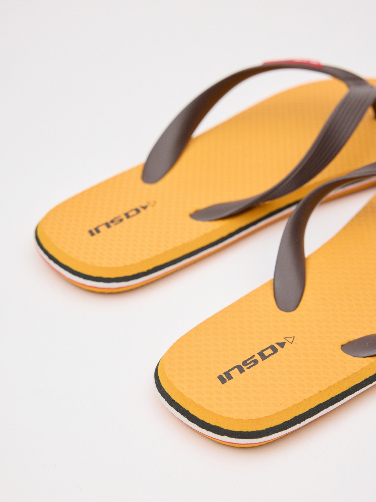 Yellow flip flop with engraved strips mustard detail view