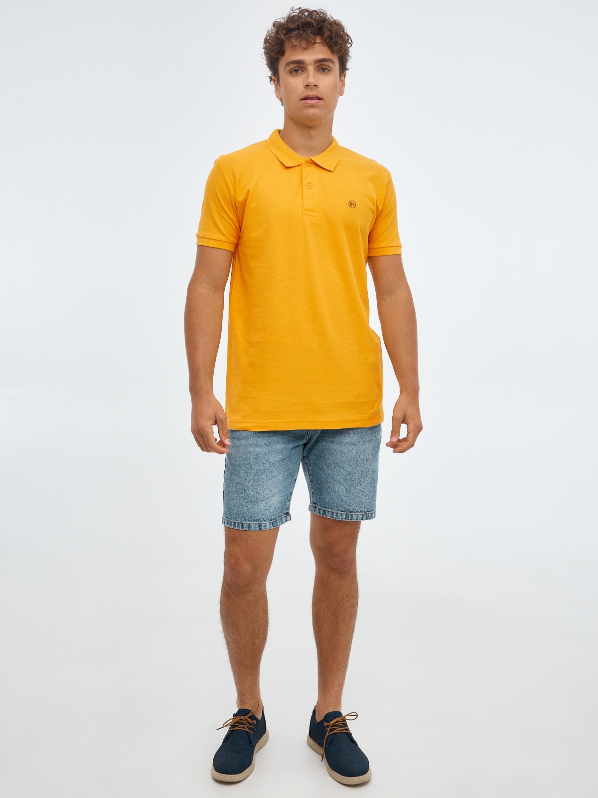 Basic polo shirt with engraved logo ochre front view