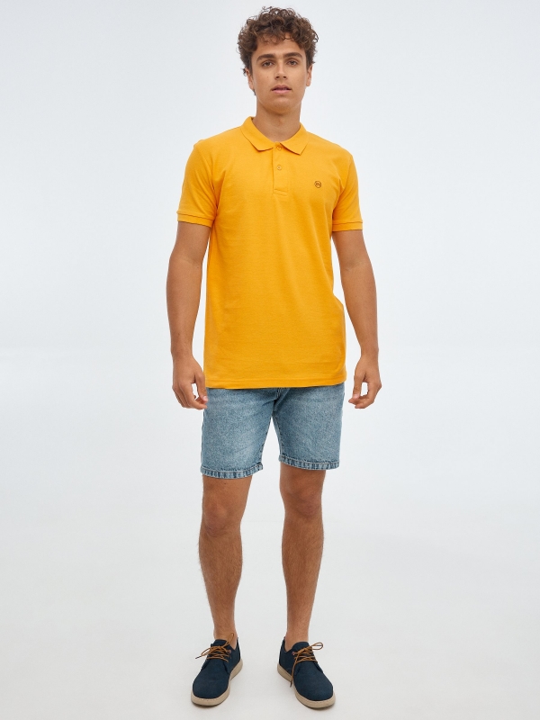 Basic polo shirt with engraved logo ochre front view