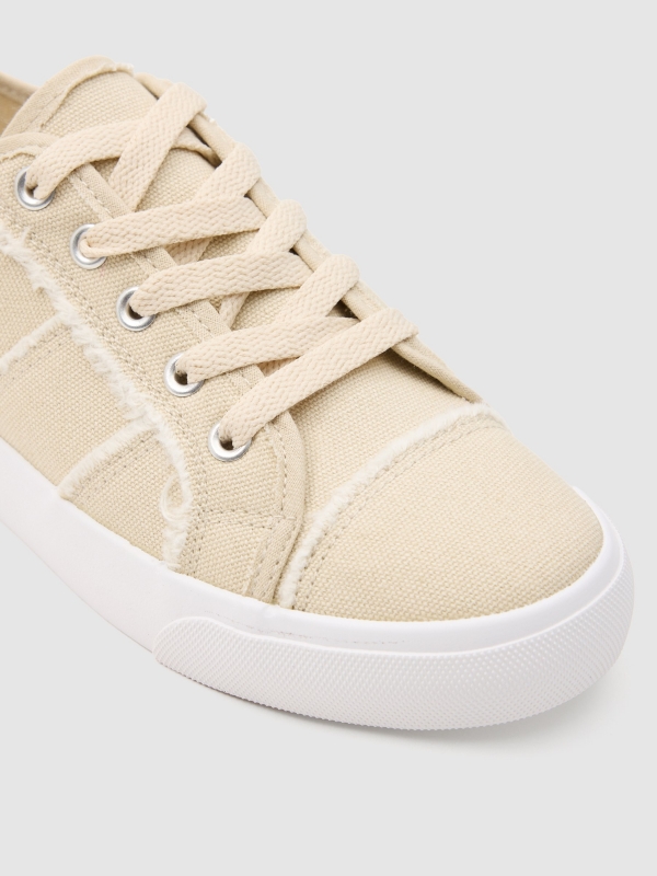 Canvas sneaker untucked sand detail view