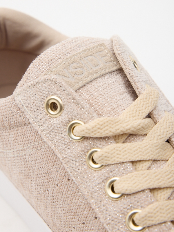 Natural canvas sneaker sand detail view