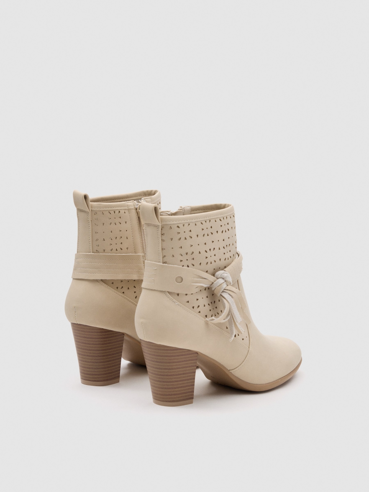 Cream leather-effect medium heel ankle boot with die-cut side bow sand 45º back view