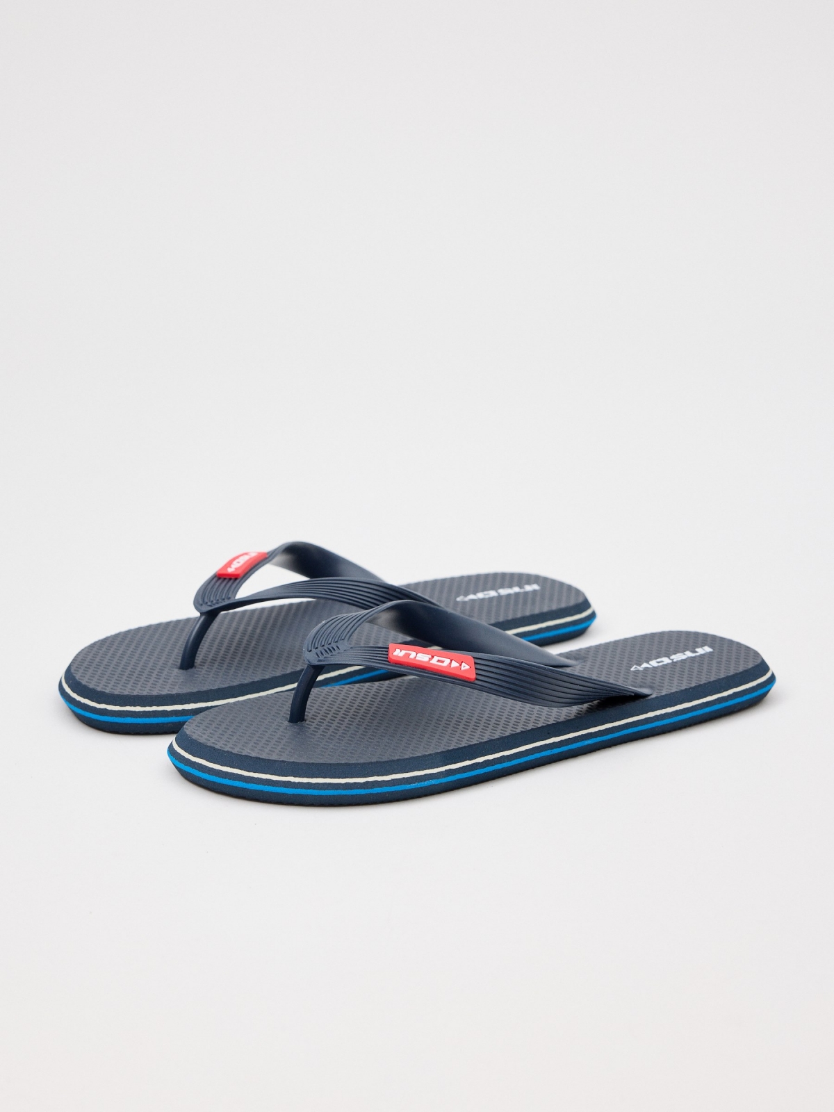 Navy blue flip flops with engraved strips 45º front view
