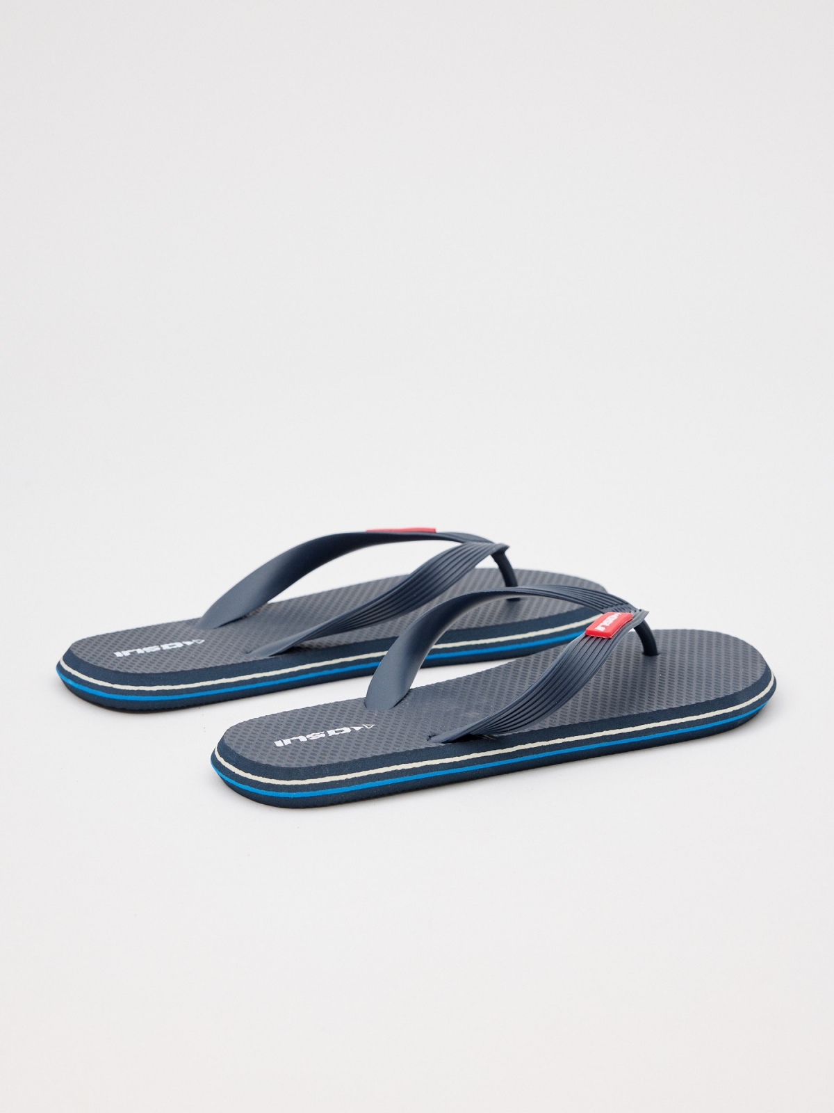 Navy blue flip flops with engraved strips 45º back view