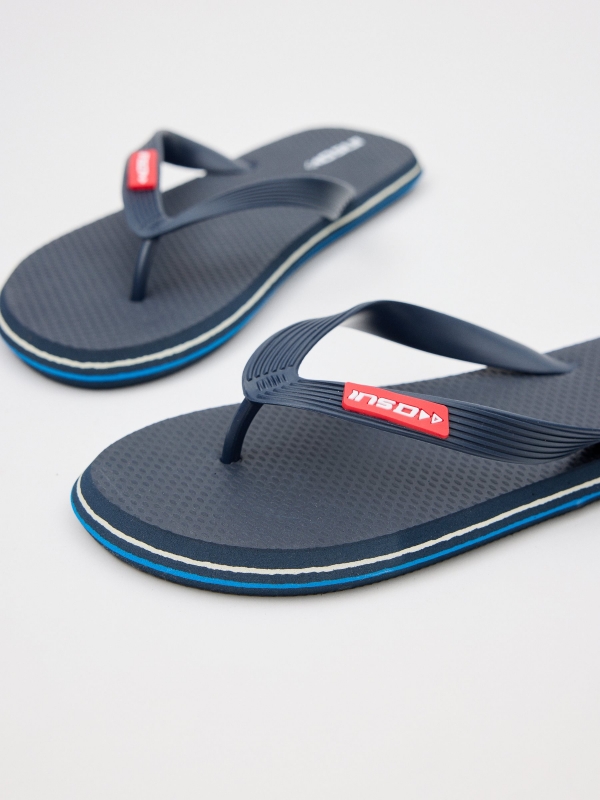 Navy blue flip flops with engraved strips navy detail view