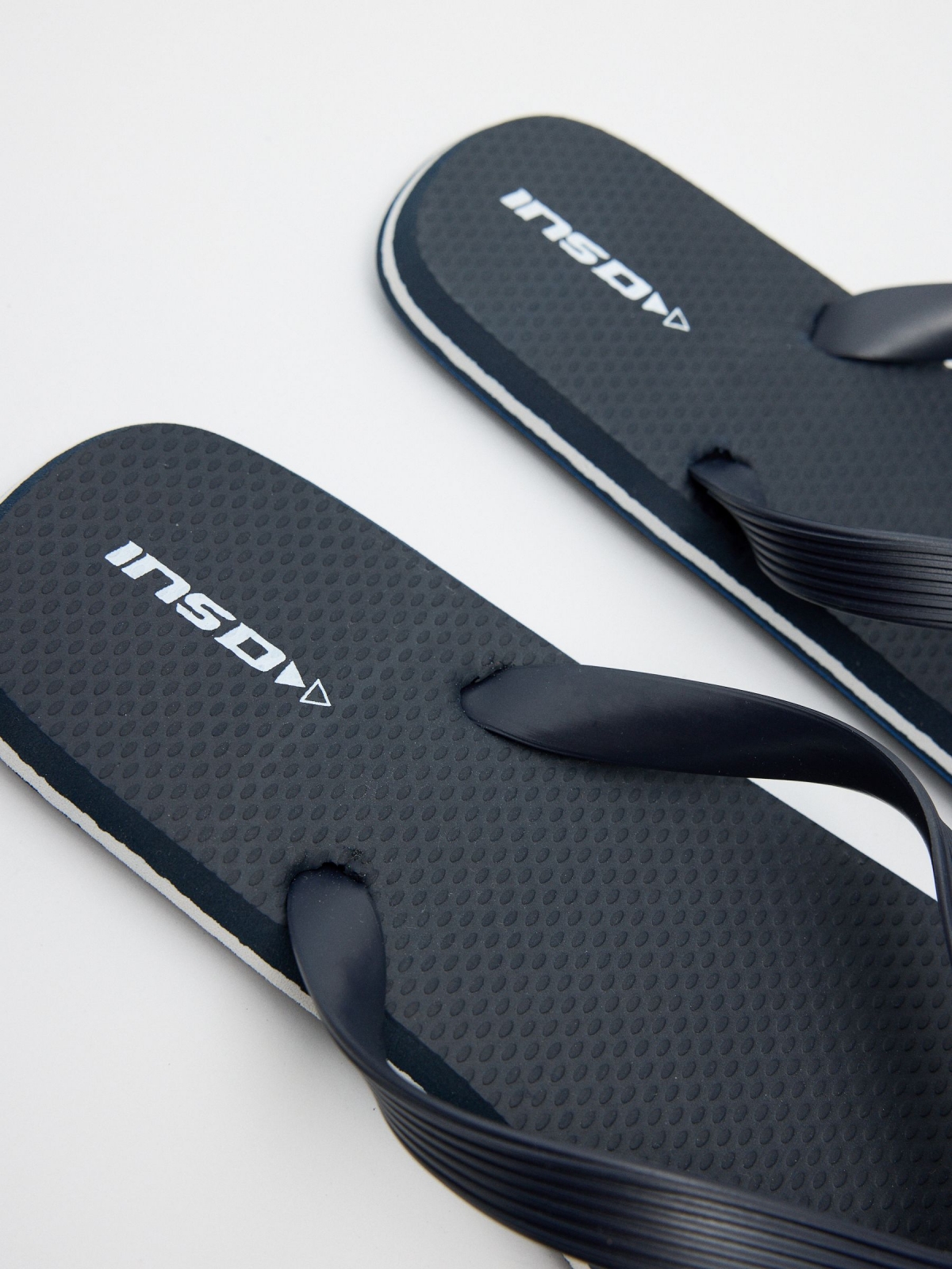 Navy blue flip flops with engraved strips navy detail view
