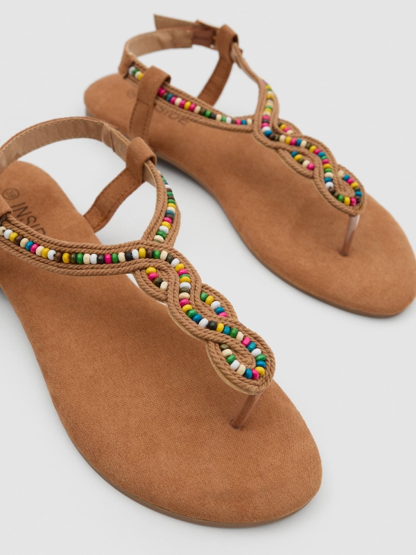 Ethnic sandals sand detail view