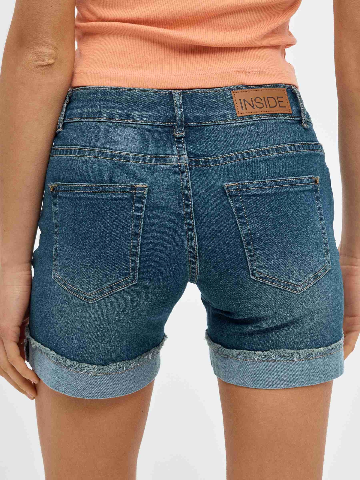 Ripped denim shorts with frayed hem blue detail view