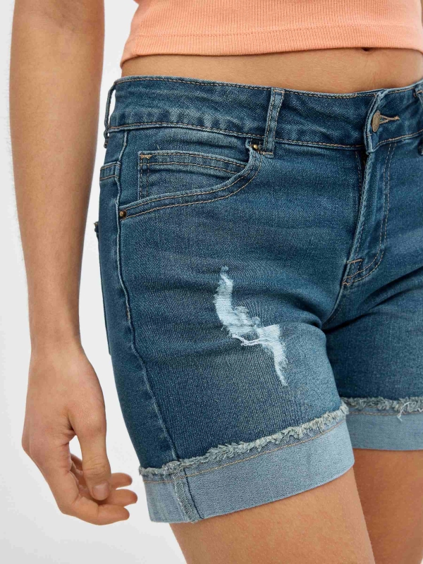Ripped denim shorts with frayed hem blue detail view