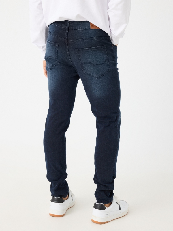 Dark slim jeans blue middle back view
