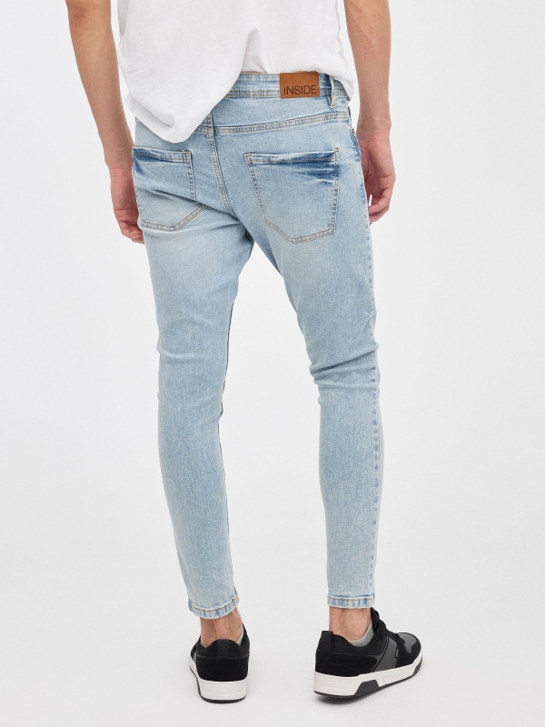 Light denim skinny jeans blue middle back view