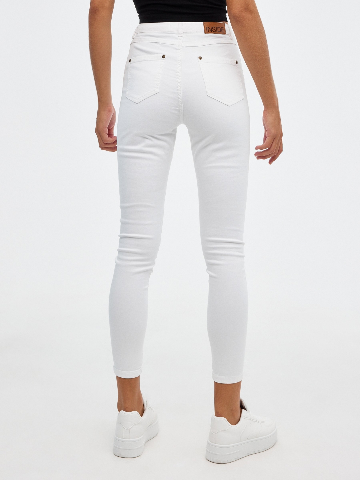 High rise skinny pants white middle back view