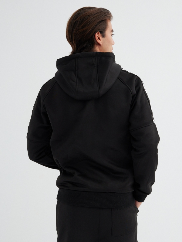 Zip-up hoodie with text black middle back view