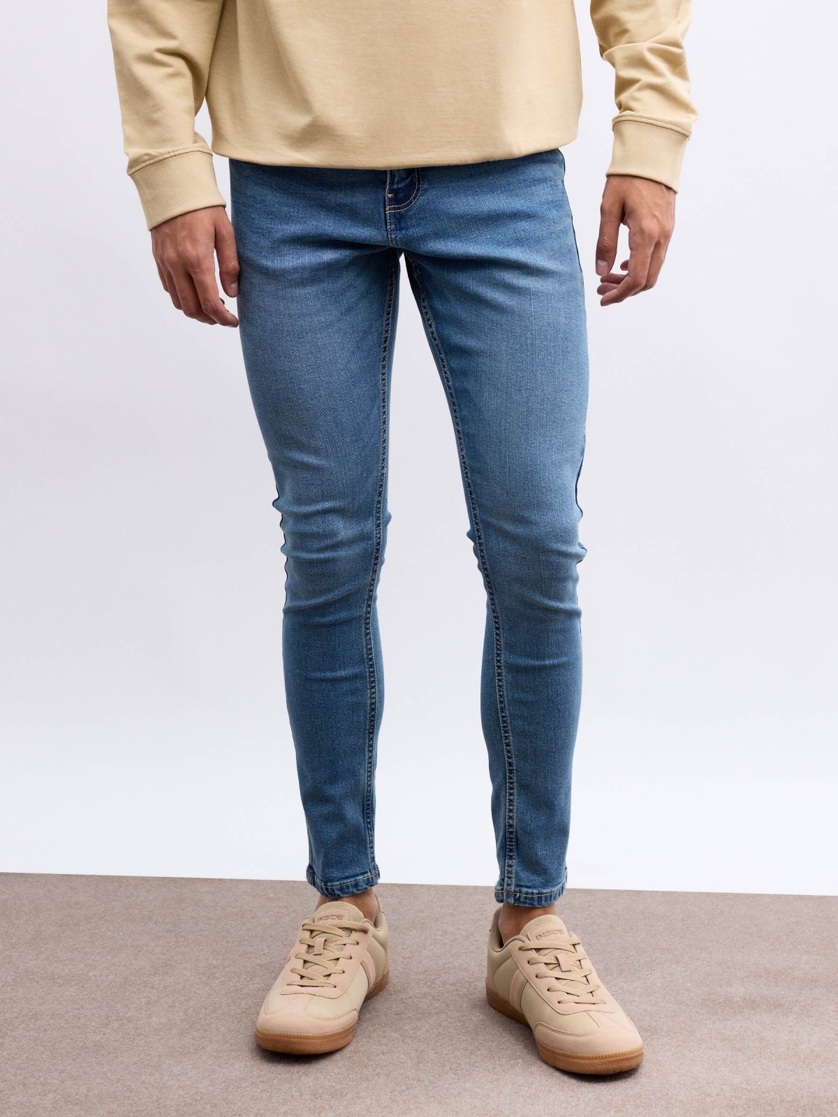 Worn skinny jeans blue middle front view