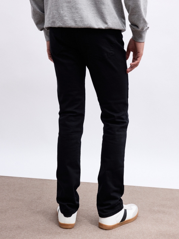 Coloured slim jeans black middle back view