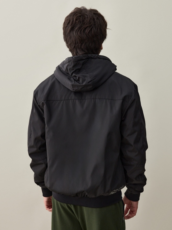 Black padded jacket black middle back view