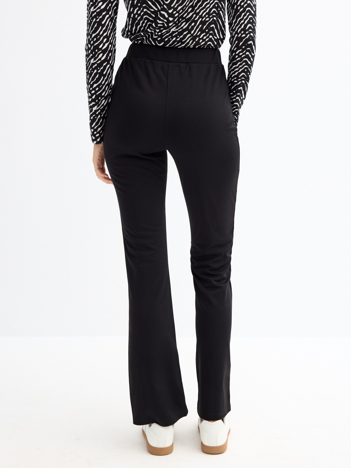 Flared leggings with a slit black middle back view