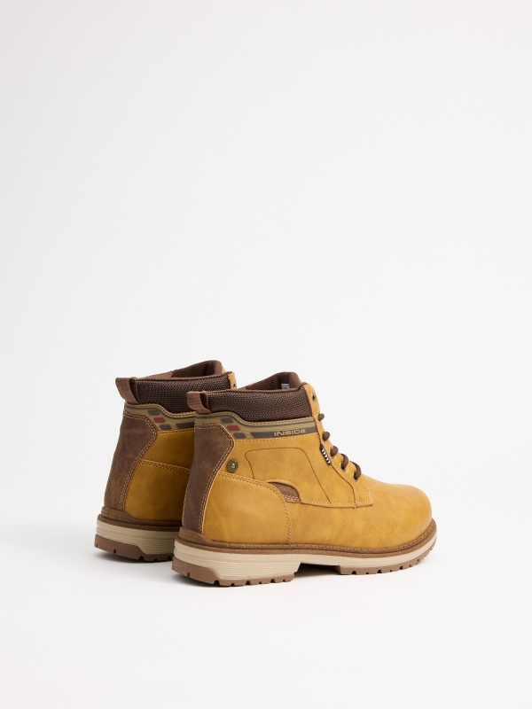 Mustard mountaineering boot with track sole yellow 45º back view