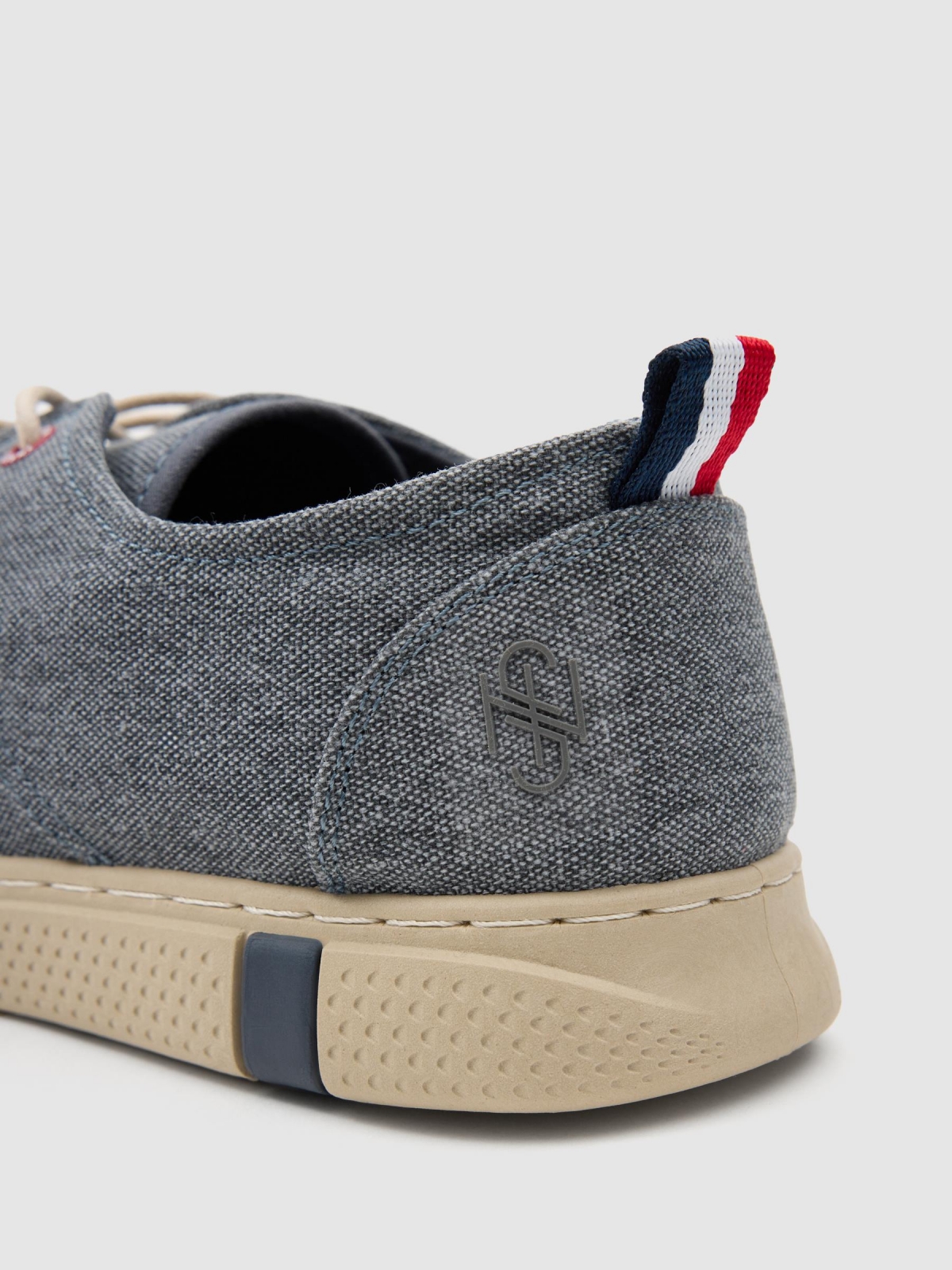 Worn canvas sneaker dark blue detail view