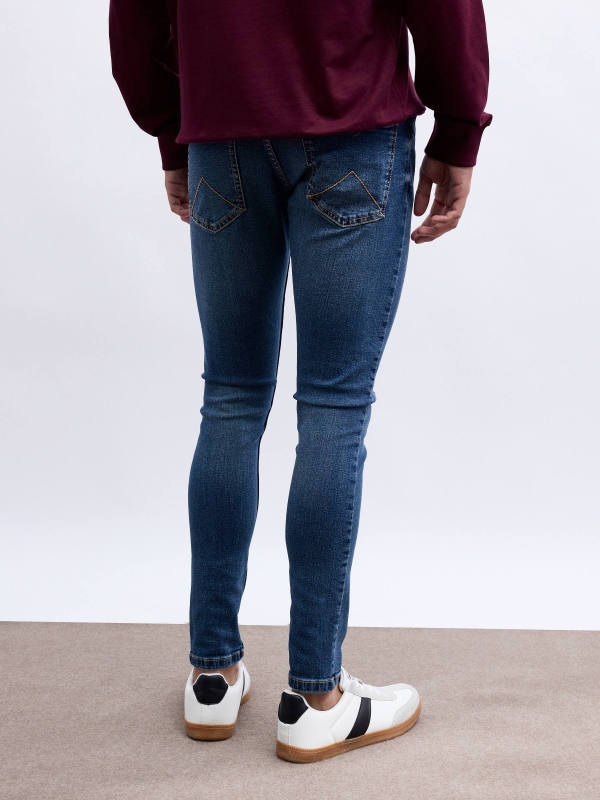 Jeans skinny con rotos azul vista media trasera