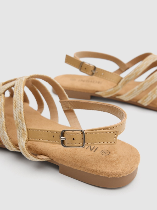 Raffia straps sandal sand detail view