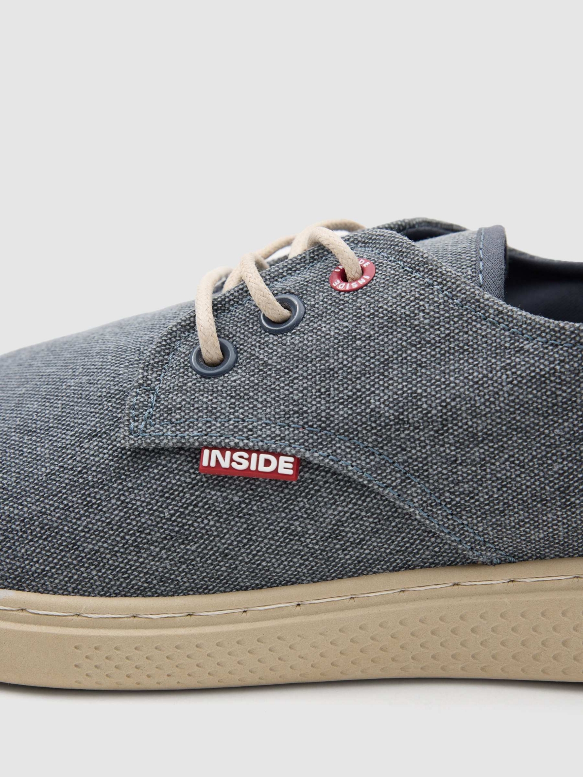 Worn canvas sneaker dark blue detail view