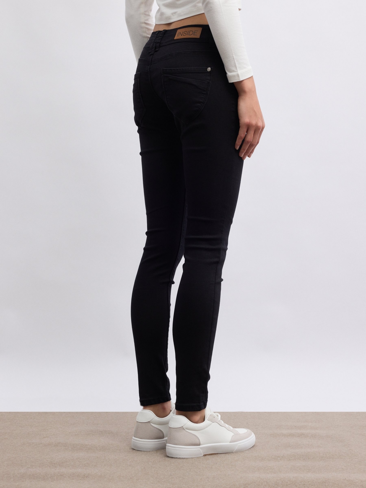 Thigh faint washed double button low-rise skinny jeans black middle back view