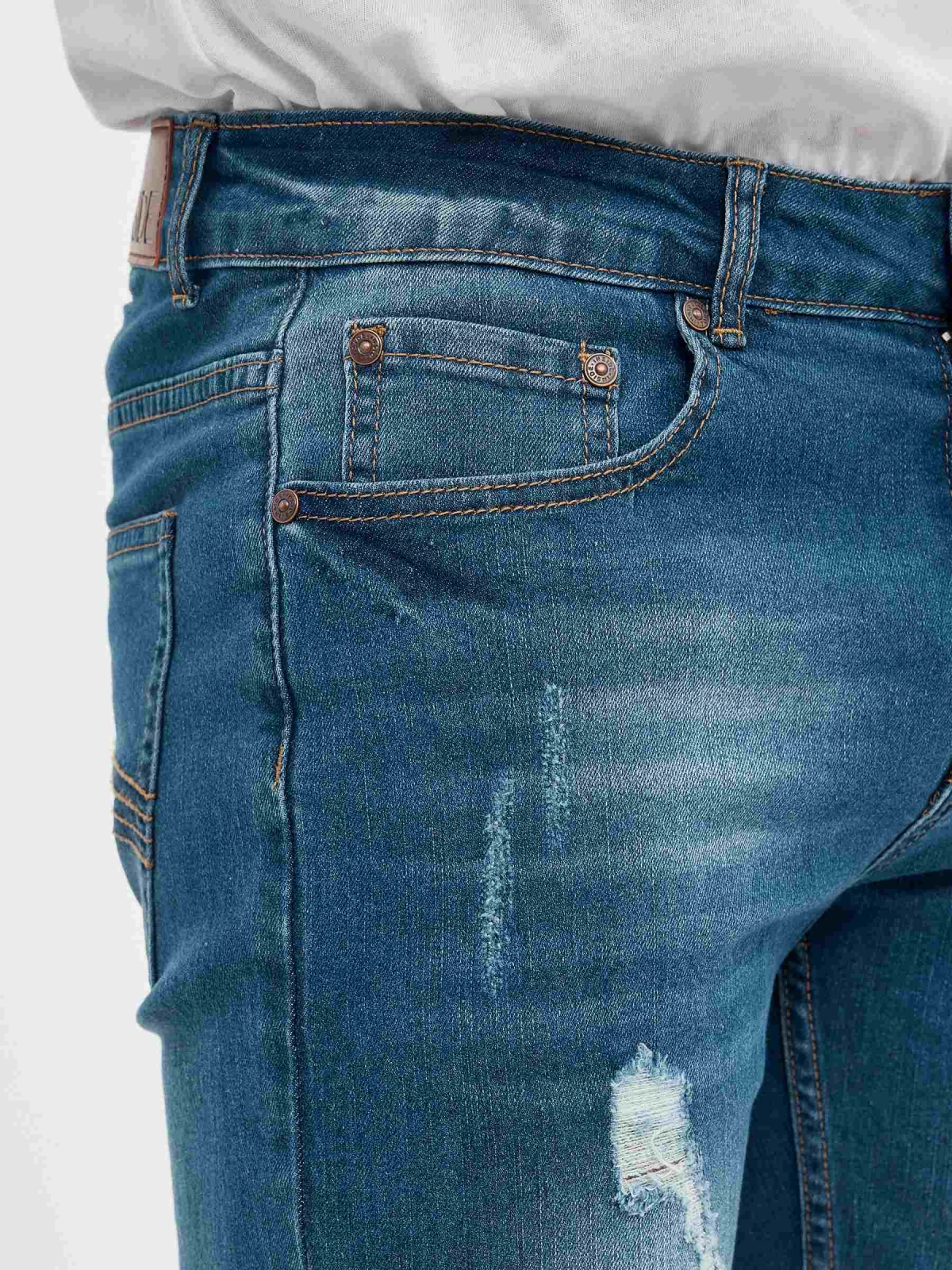 Ripped denim bermuda blue detail view