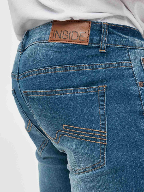 Ripped denim bermuda blue detail view