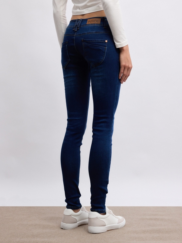 Low-rise distressed skinny jeans blue middle back view