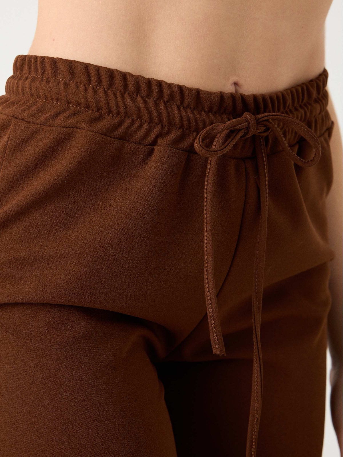 Rubber cargo pants brown detail view