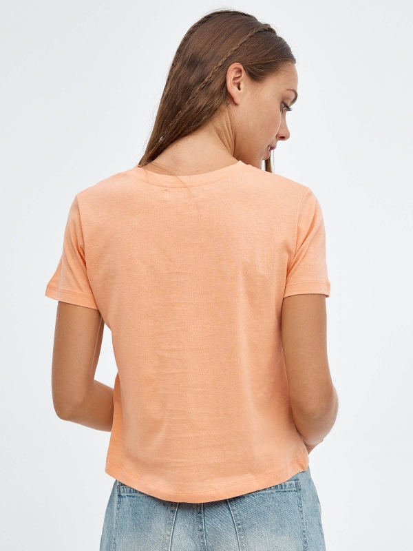 Wears Boots T-shirt peach middle back view