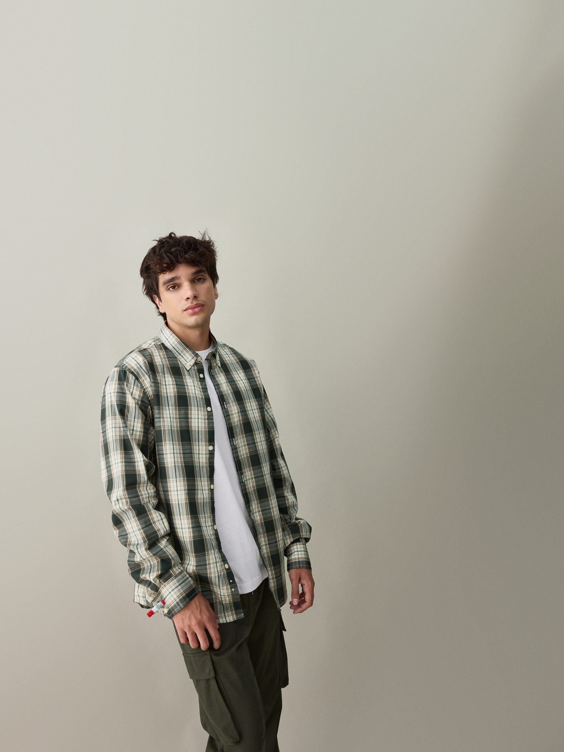 Green checkered shirt beige middle front view