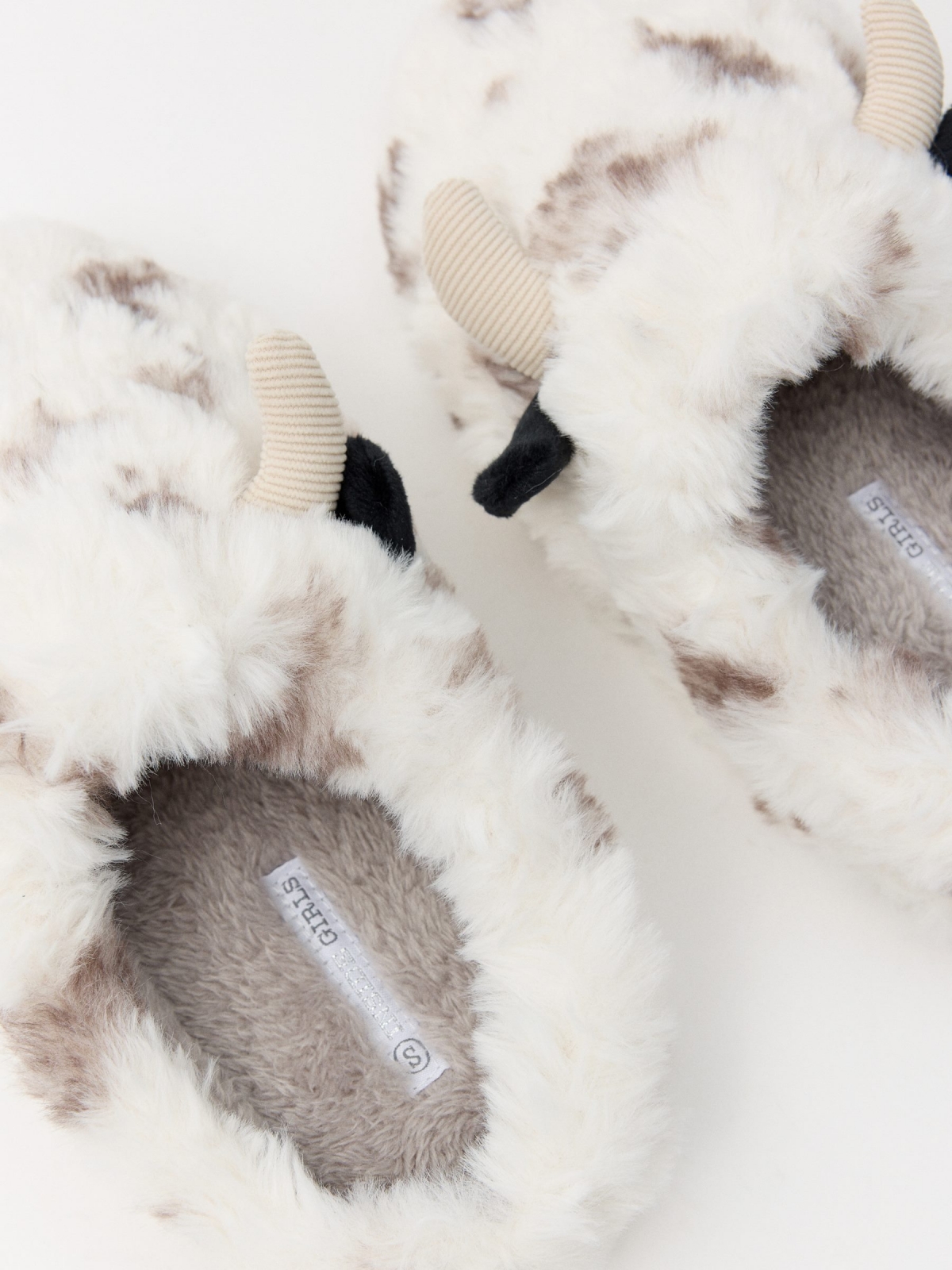 Cow slippers off white detail view