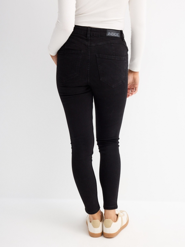 Black push up skinny jeans black middle back view