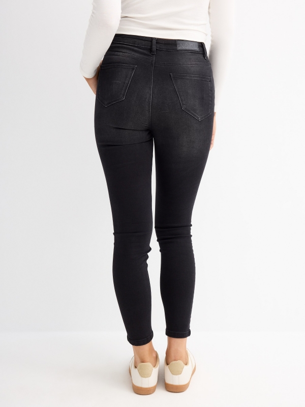 Black high rise skinny jeans black middle back view